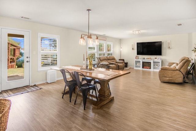 dining area with a notable chandelier and light wood-type flooring