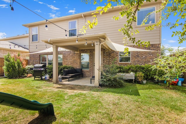 rear view of house featuring a yard and a patio area