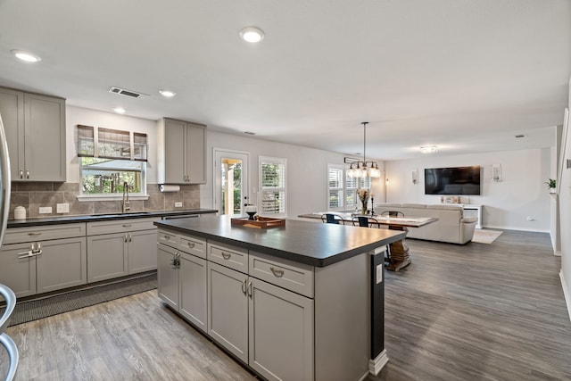 1813 Aslynn Cir, Aubrey, TX 76227 - kitchen featuring dark countertops, gray cabinetry, wood finished floors, and recessed lighting