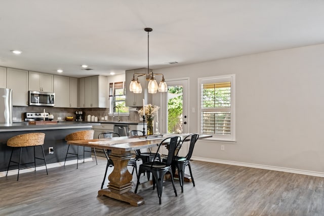1813 Aslynn Cir, Aubrey, TX 76227 - dining space with plenty of natural light, wood finished floors, baseboards, and recessed lighting
