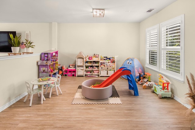 recreation room with light hardwood / wood-style flooring