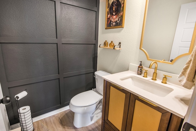 bathroom featuring hardwood / wood-style floors, vanity, and toilet