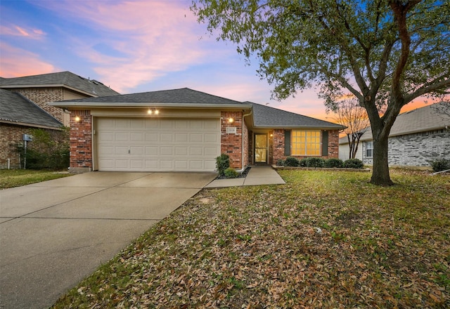 view of front of home with a yard and a garage