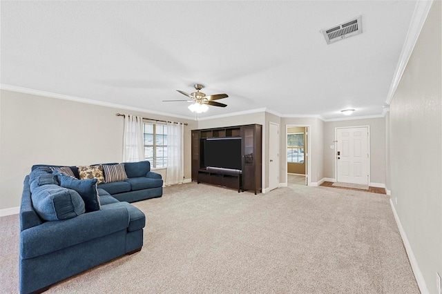 living room featuring ceiling fan, ornamental molding, and light carpet