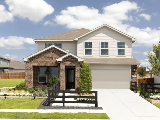 view of front of property with a garage and a front lawn