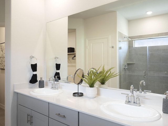 bathroom with vanity and a shower with door