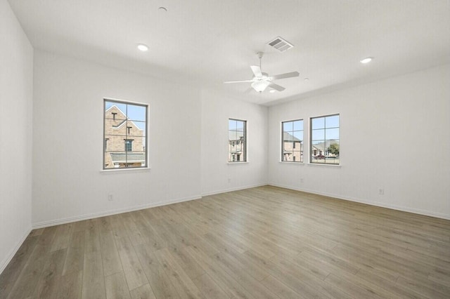 unfurnished room featuring baseboards, visible vents, ceiling fan, wood finished floors, and recessed lighting