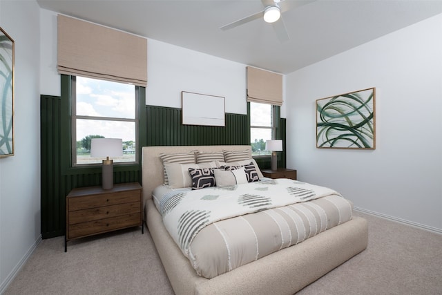 bedroom with a ceiling fan, light colored carpet, and baseboards