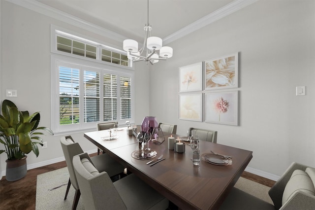 dining space with ornamental molding and a notable chandelier