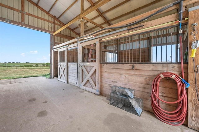 view of horse barn featuring a rural view