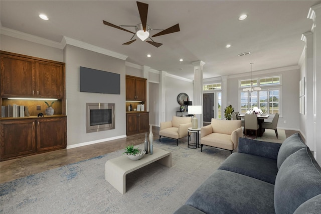 living room featuring ceiling fan with notable chandelier and ornamental molding