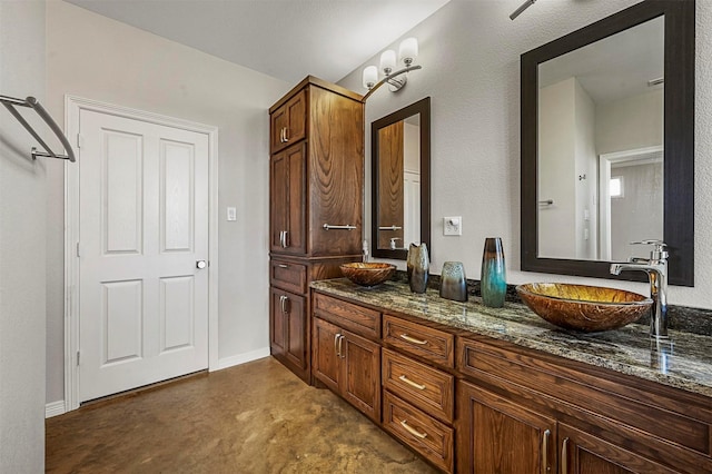 bathroom with vanity and concrete floors