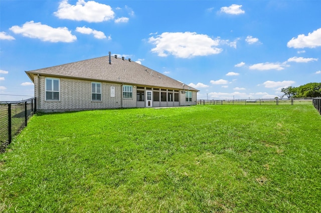 back of house with a lawn