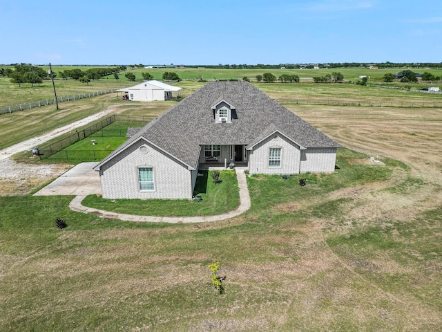 view of front facade with a front yard and a rural view