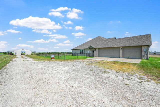 ranch-style home featuring a garage and a front yard