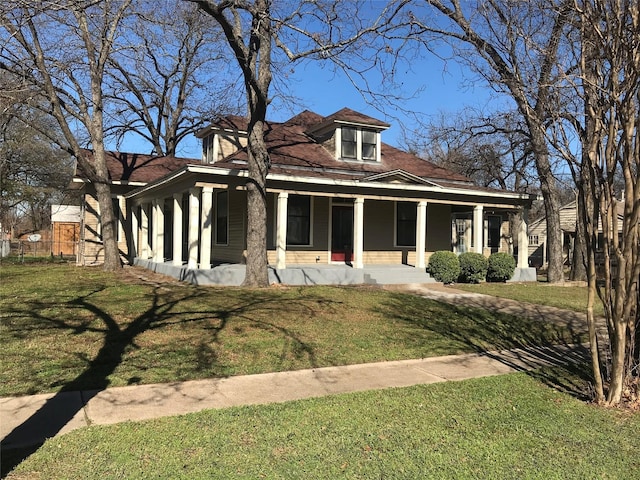 view of front of property with a porch and a front yard