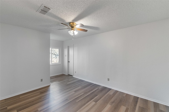 spare room featuring a textured ceiling, hardwood / wood-style flooring, and ceiling fan