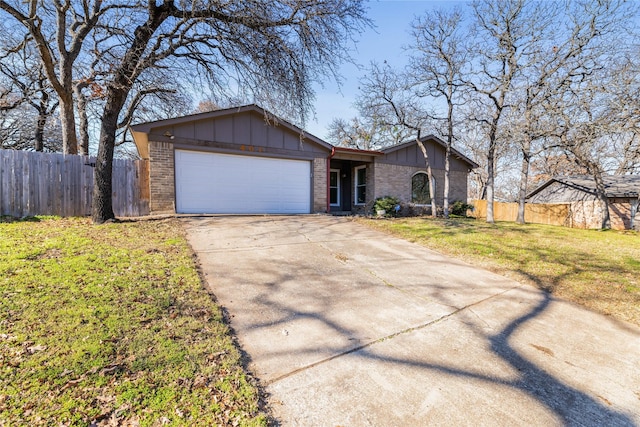 ranch-style home featuring a front yard and a garage