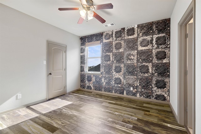 unfurnished room with ceiling fan and wood-type flooring