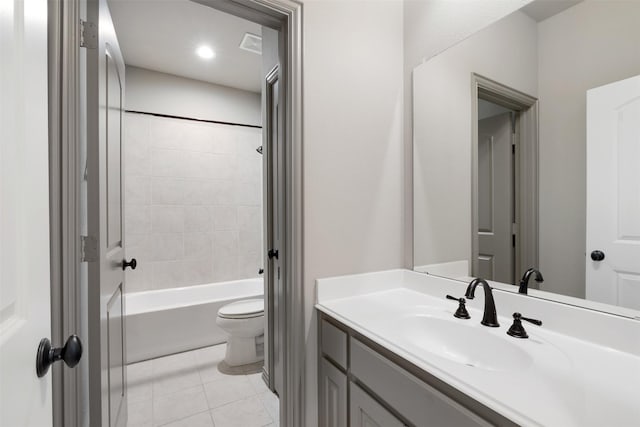 full bathroom with toilet, vanity, tiled shower / bath, and tile patterned flooring