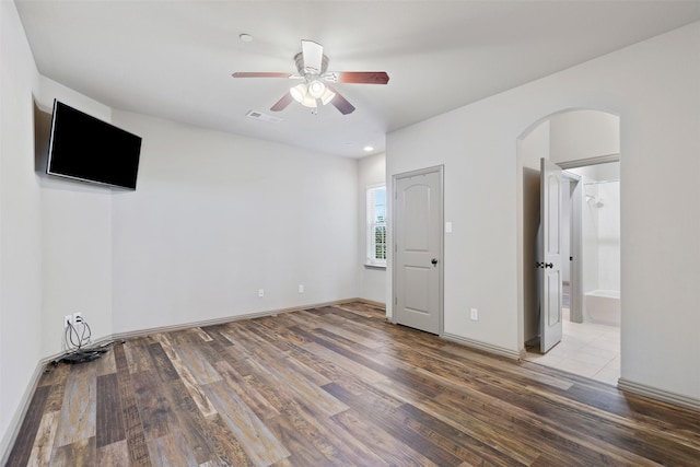 unfurnished bedroom with ceiling fan, light wood-type flooring, and connected bathroom