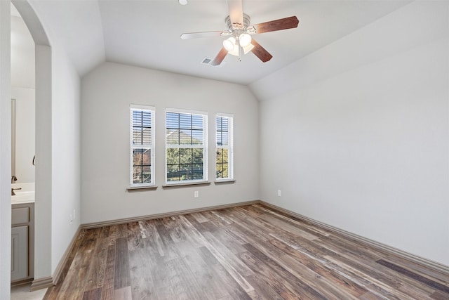 spare room with ceiling fan, wood-type flooring, and lofted ceiling