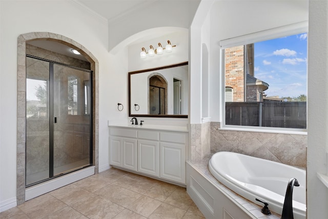 bathroom with tile patterned flooring, vanity, ornamental molding, and plus walk in shower