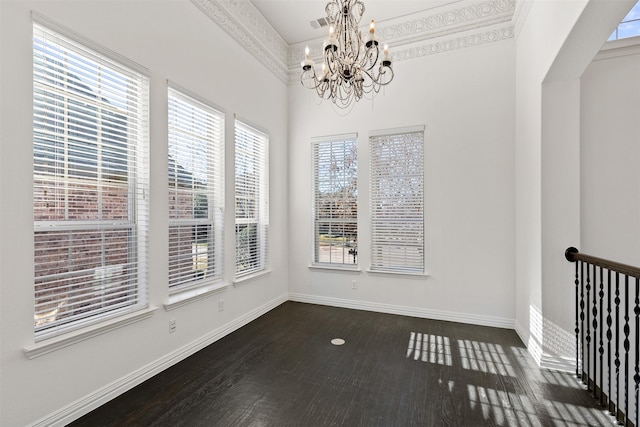 unfurnished dining area featuring a notable chandelier and crown molding