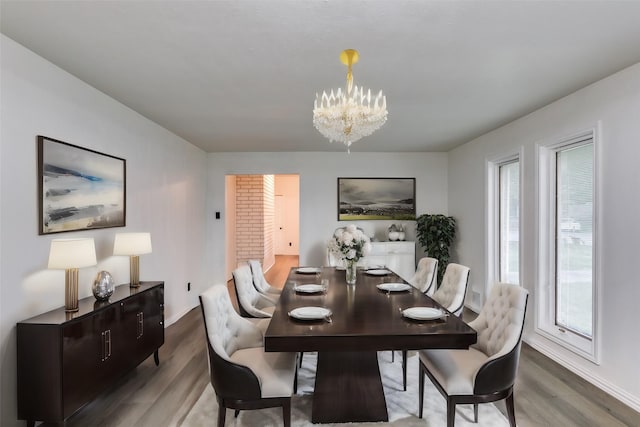 dining room featuring dark wood-type flooring and an inviting chandelier