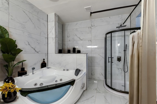 bathroom featuring plus walk in shower and tile walls