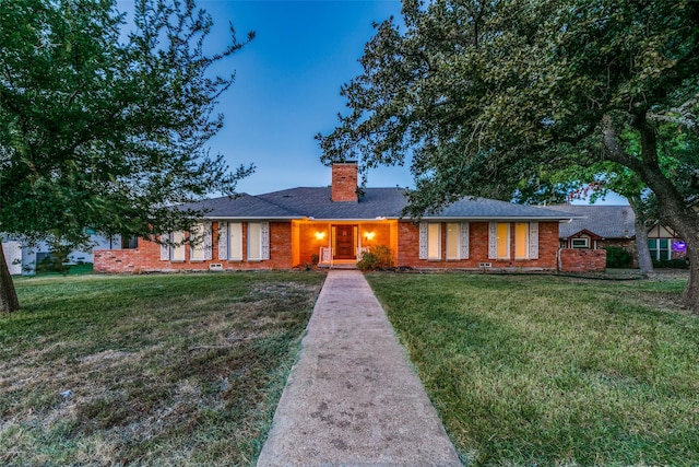 ranch-style home featuring a front yard