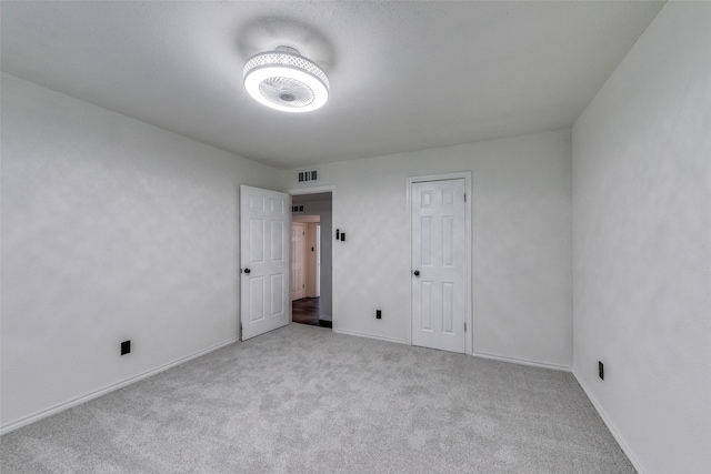 unfurnished room with light colored carpet