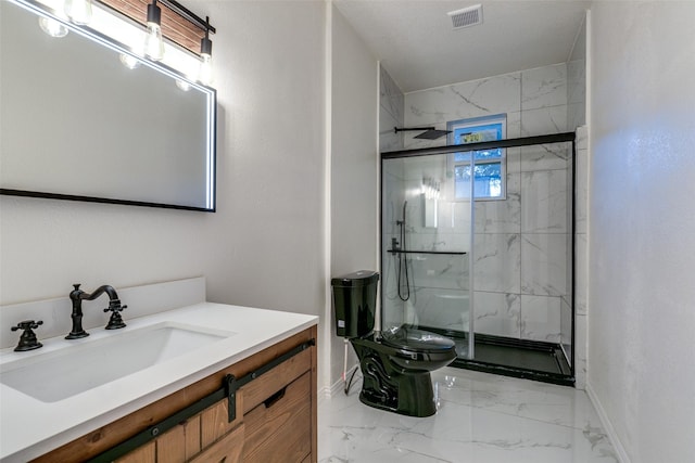 bathroom featuring a shower with door, vanity, and toilet