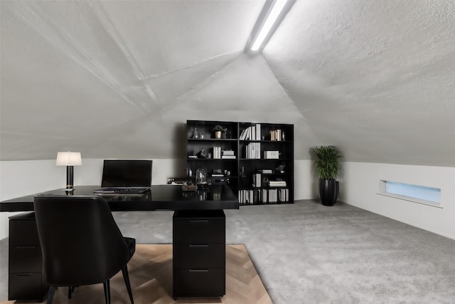 office space with vaulted ceiling and a textured ceiling