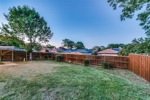 view of yard at dusk