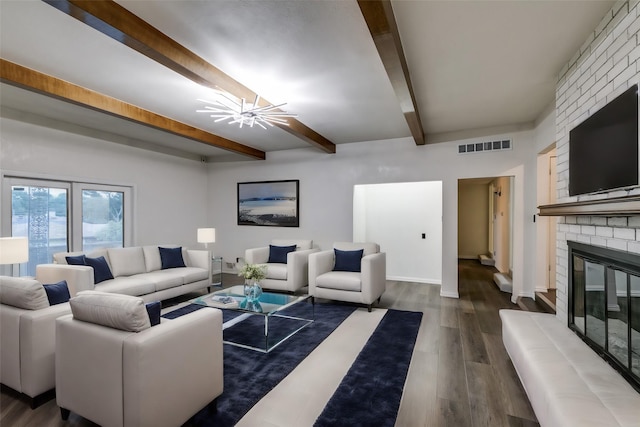 living room with a fireplace, beam ceiling, and hardwood / wood-style flooring