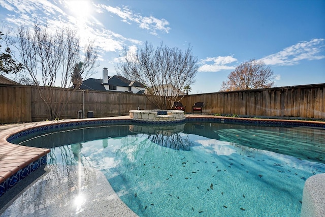 view of swimming pool with an in ground hot tub