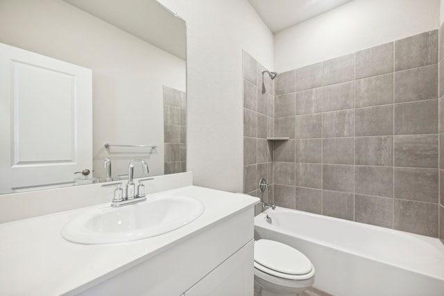 full bathroom with vanity, toilet, and tiled shower / bath