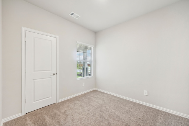 empty room featuring light carpet