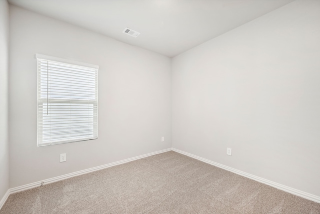 carpeted spare room featuring a healthy amount of sunlight