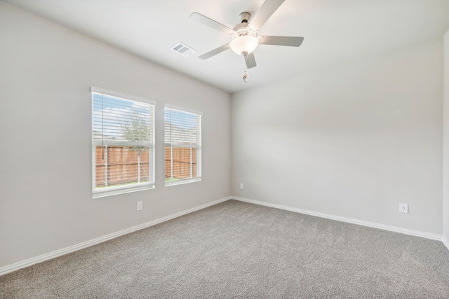 empty room with ceiling fan and carpet