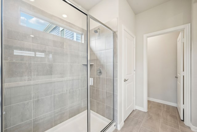 bathroom featuring tile patterned flooring and an enclosed shower