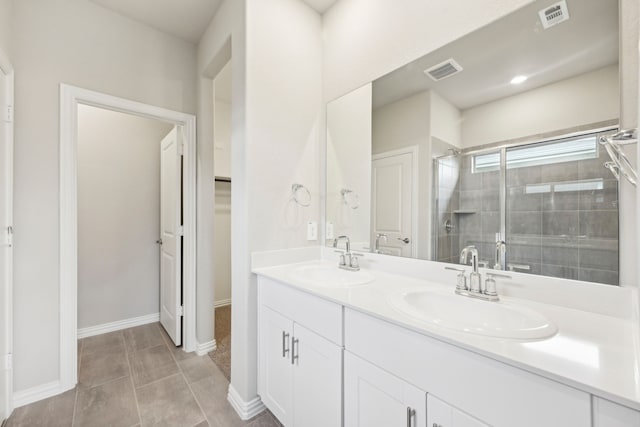 bathroom with tile patterned flooring, vanity, and walk in shower