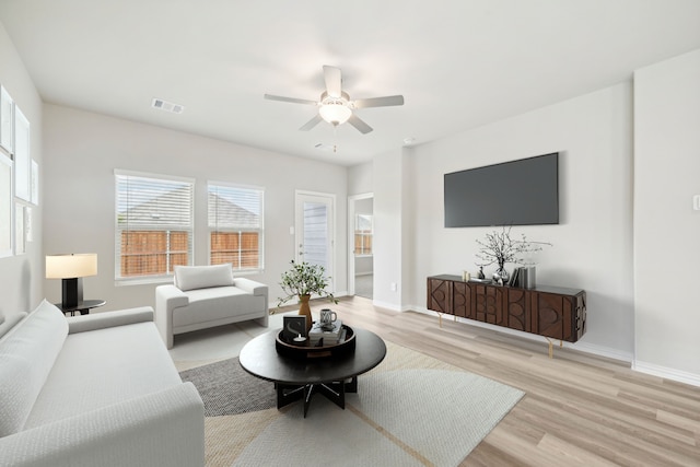 living room featuring light hardwood / wood-style floors and ceiling fan