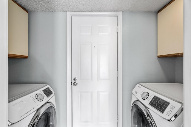 washroom featuring separate washer and dryer, cabinets, and a textured ceiling