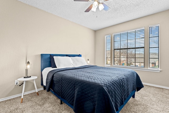 bedroom featuring carpet flooring, a textured ceiling, and ceiling fan