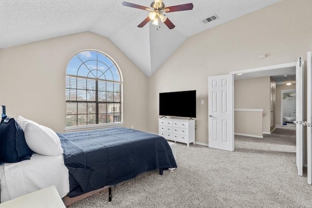 bedroom featuring light carpet, a textured ceiling, vaulted ceiling, and ceiling fan