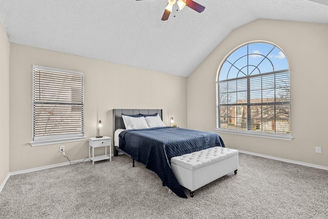 carpeted bedroom with ceiling fan, a textured ceiling, and vaulted ceiling