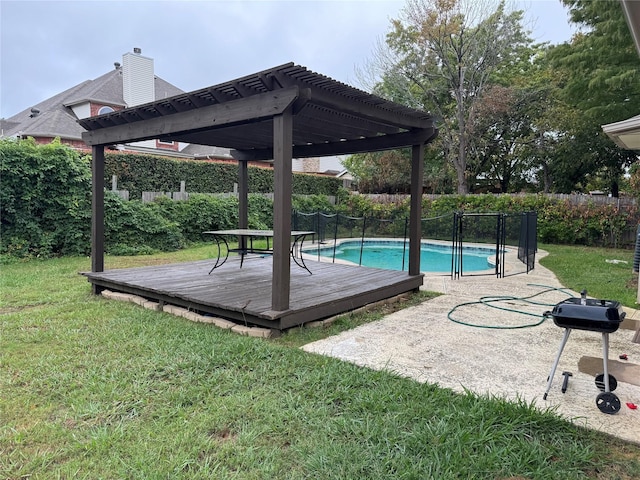 view of swimming pool with a pergola, a yard, and a deck