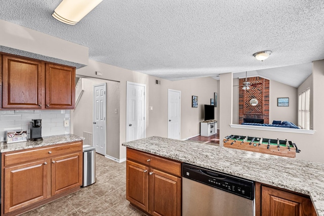 kitchen featuring lofted ceiling, stainless steel dishwasher, decorative backsplash, ceiling fan, and light stone counters